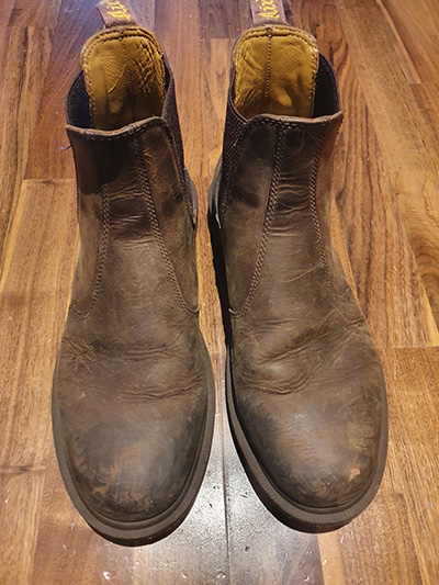 Pair of worn out, brown Dr. Marten boots